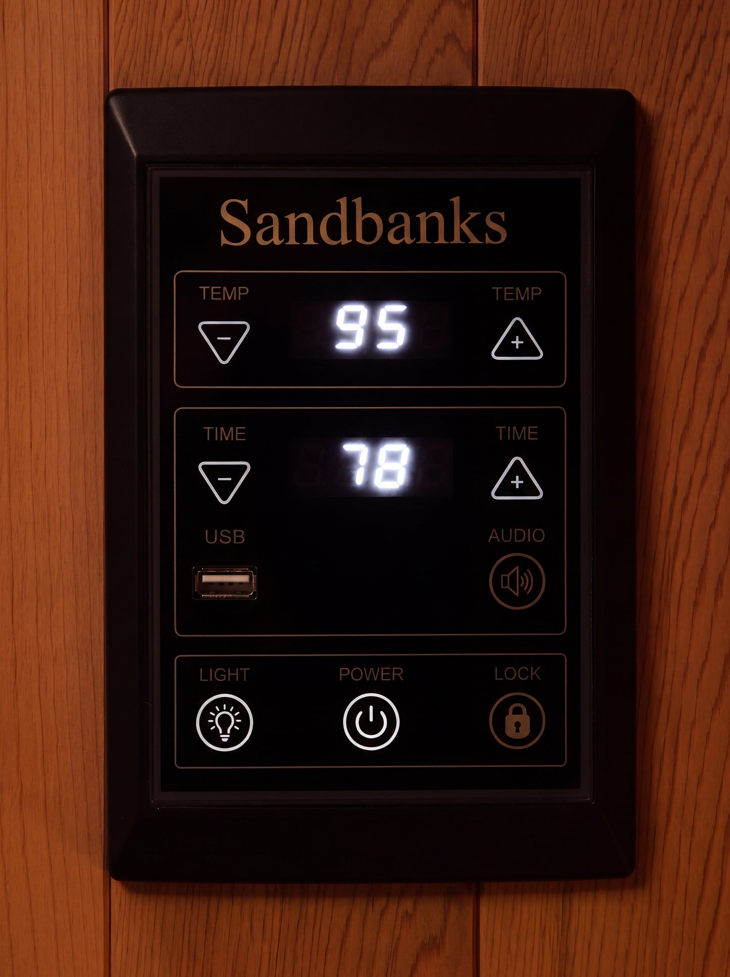 Full spectrum carbon heater panel glowing behind black mesh in cedar frame