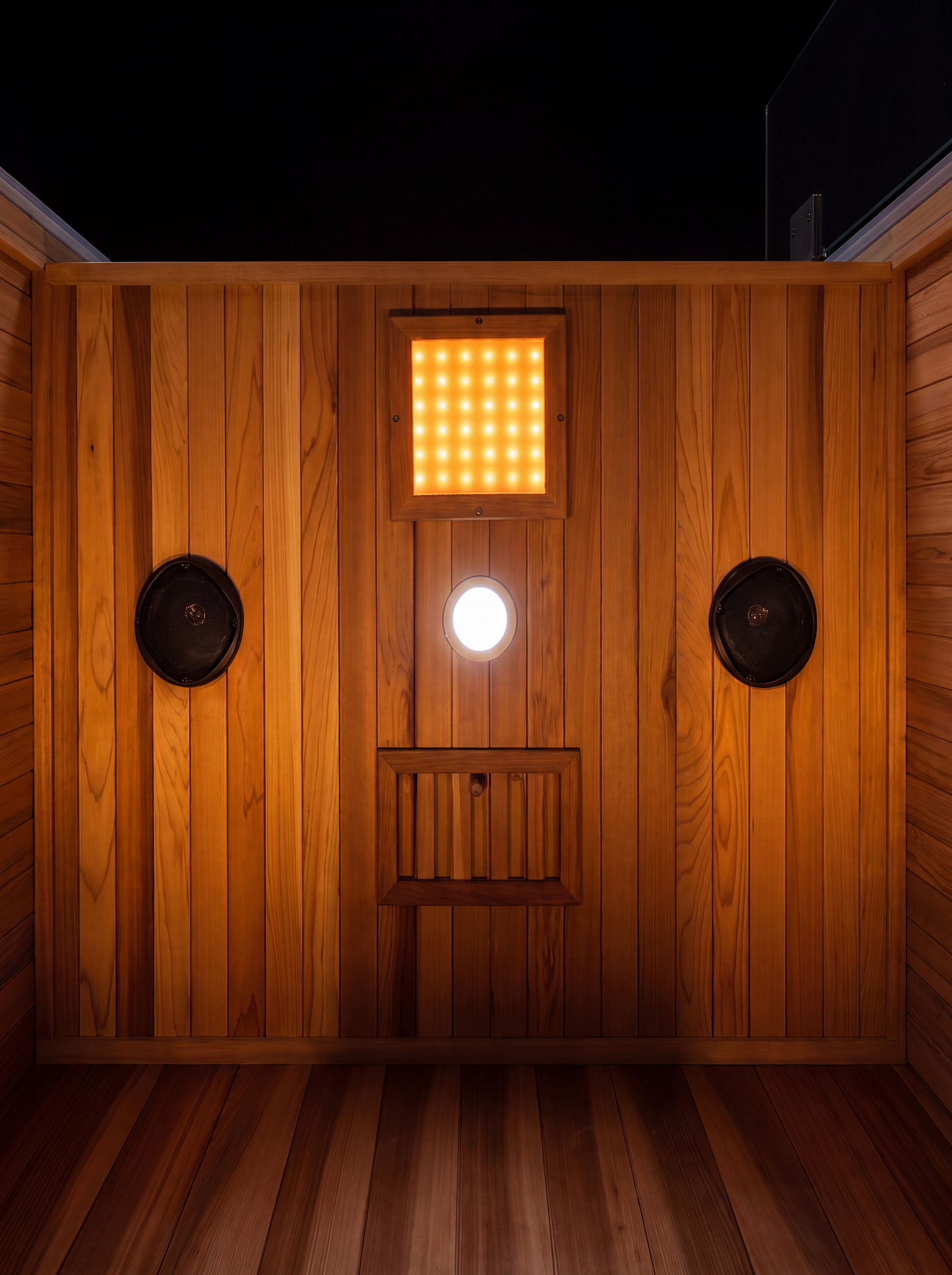 Solas Two from above — cedar roof, glass door and glowing interior cove lighting