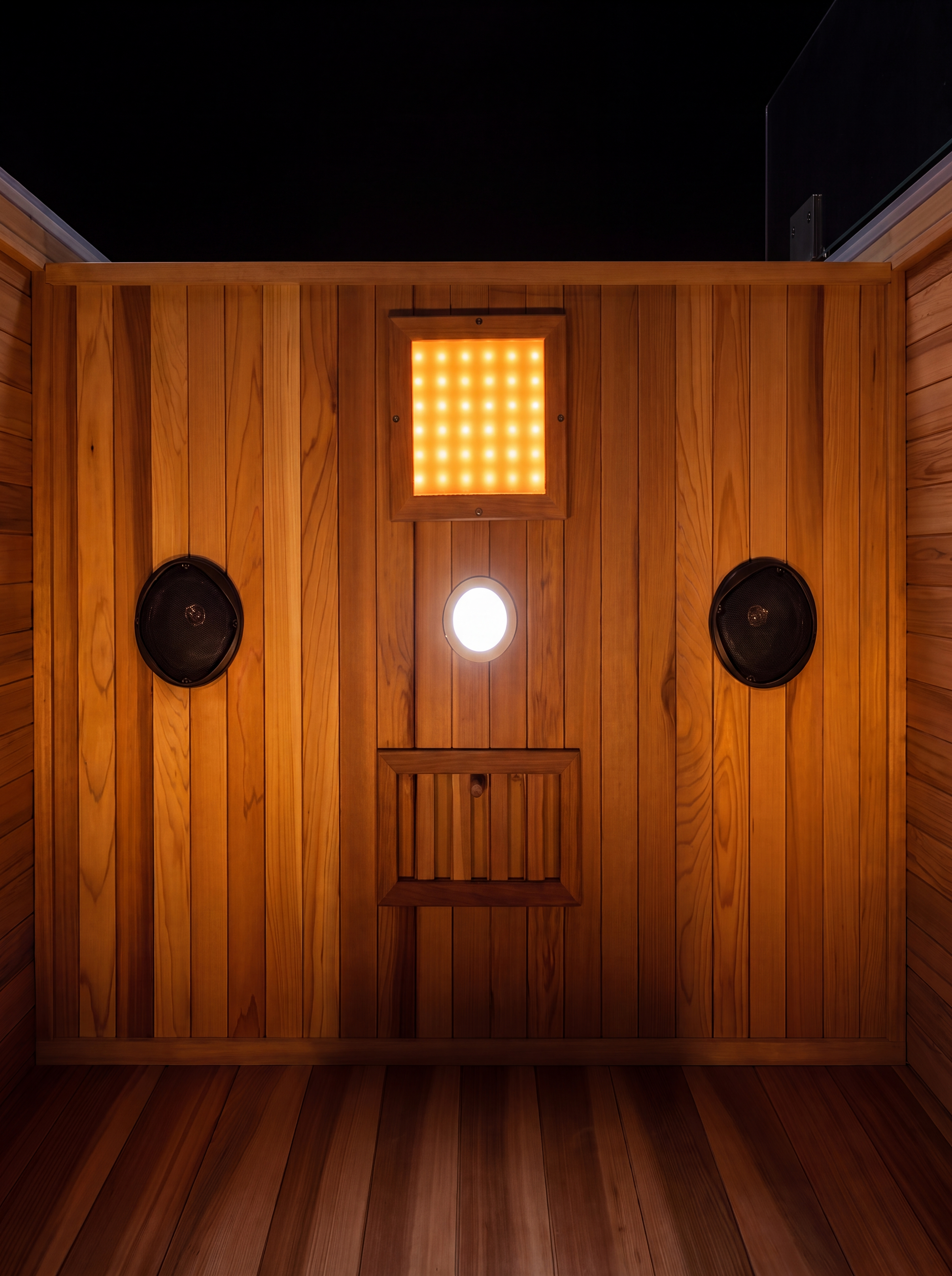 Solas Two from above — cedar roof, glass door and glowing interior cove lighting