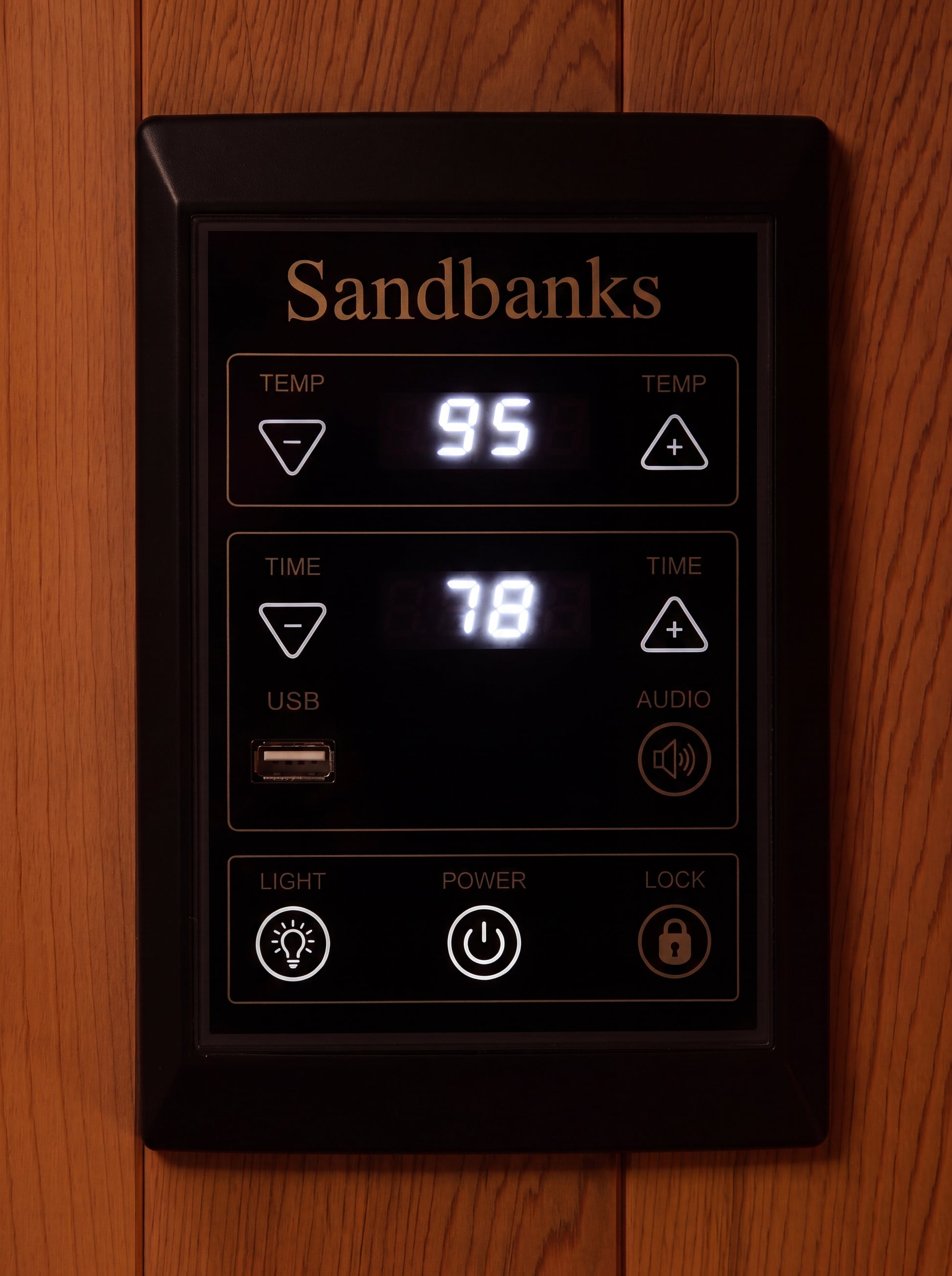 Full spectrum carbon heater panel glowing behind black mesh in cedar frame